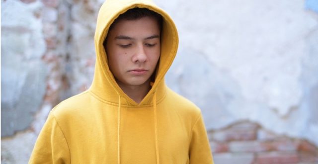 Teenage boy in a yellow hoodie